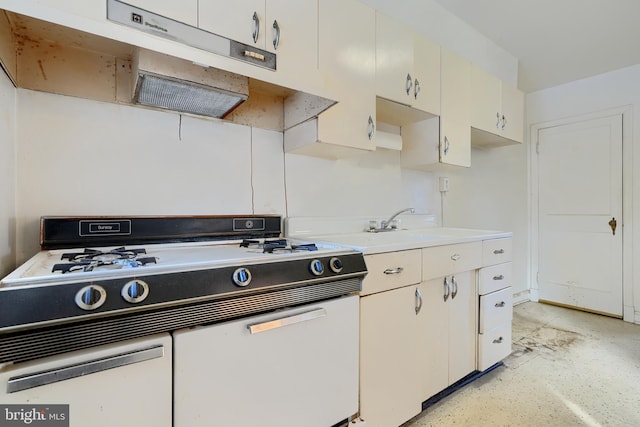 kitchen with sink, white gas range oven, and white cabinets