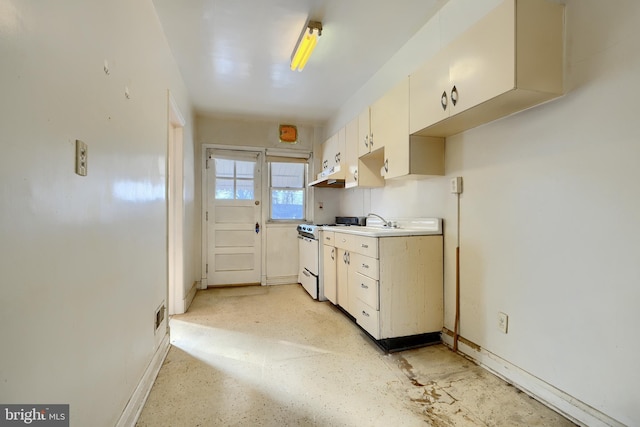 kitchen with cream cabinets, sink, and electric range