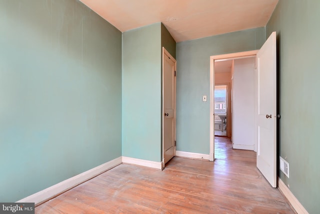 spare room featuring light hardwood / wood-style flooring