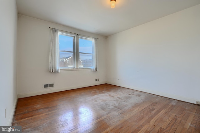 unfurnished room with wood-type flooring