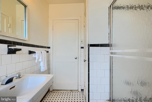 bathroom featuring tile walls, sink, tile patterned flooring, and walk in shower