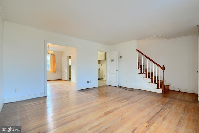 unfurnished living room featuring crown molding and light wood-type flooring