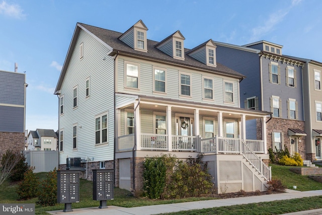 view of front of house featuring a porch and central air condition unit