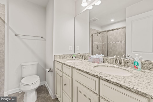 bathroom with vanity, tile patterned flooring, a shower with shower door, and toilet