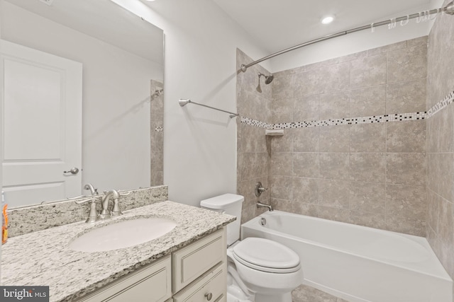 full bathroom with vanity, toilet, and tiled shower / bath