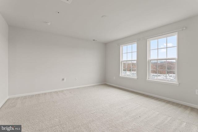 unfurnished room with light carpet