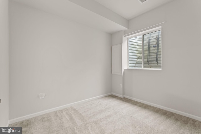 spare room with light colored carpet