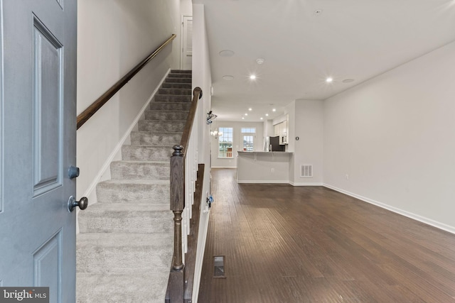 stairs featuring hardwood / wood-style flooring