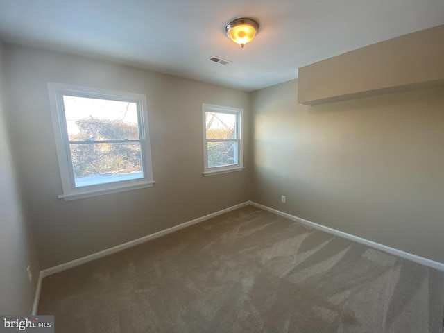 unfurnished room featuring carpet