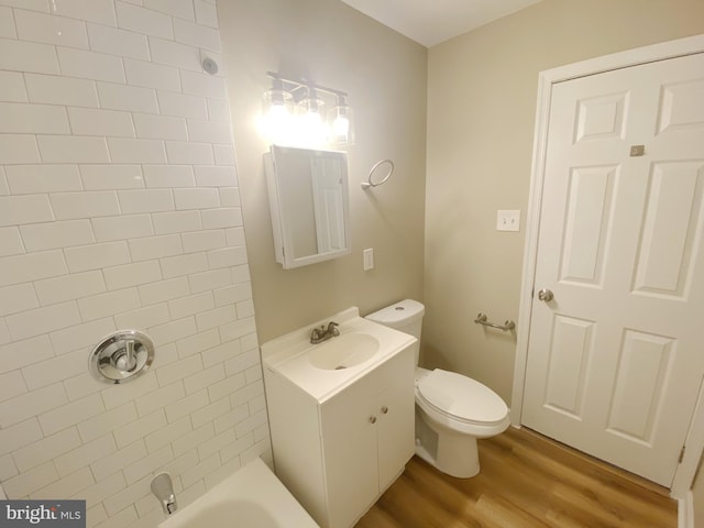 bathroom featuring vanity, toilet, and wood-type flooring