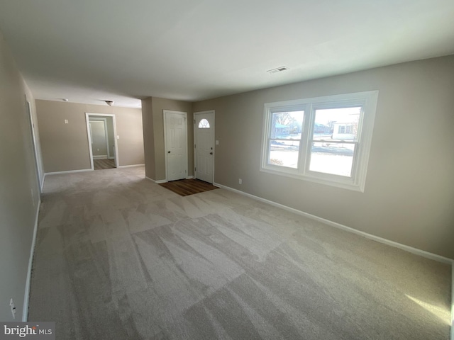 entryway featuring light colored carpet