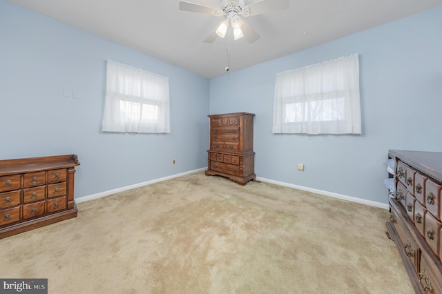 unfurnished bedroom featuring light colored carpet and ceiling fan