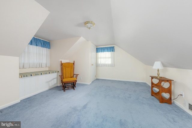 sitting room with vaulted ceiling and carpet floors