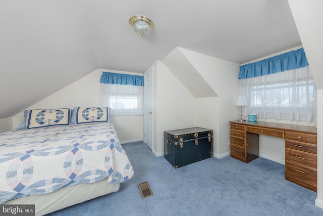 carpeted bedroom with lofted ceiling