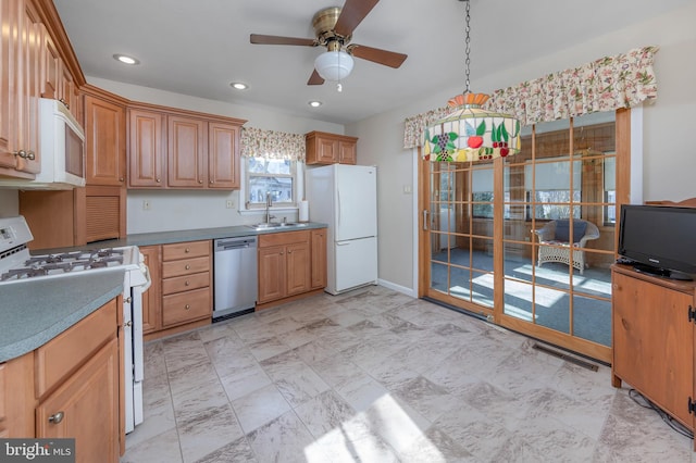 kitchen featuring sink, white appliances, decorative light fixtures, and ceiling fan