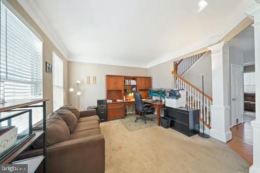 office space with crown molding and decorative columns