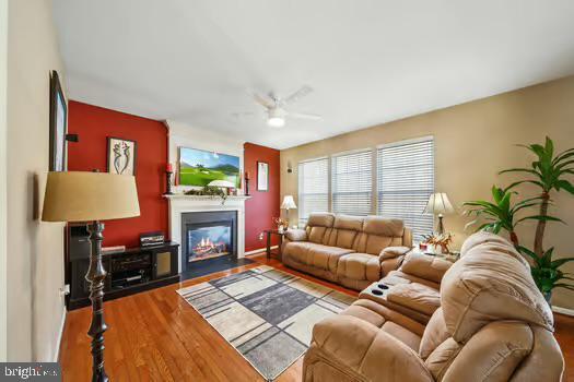 living room with hardwood / wood-style flooring and ceiling fan