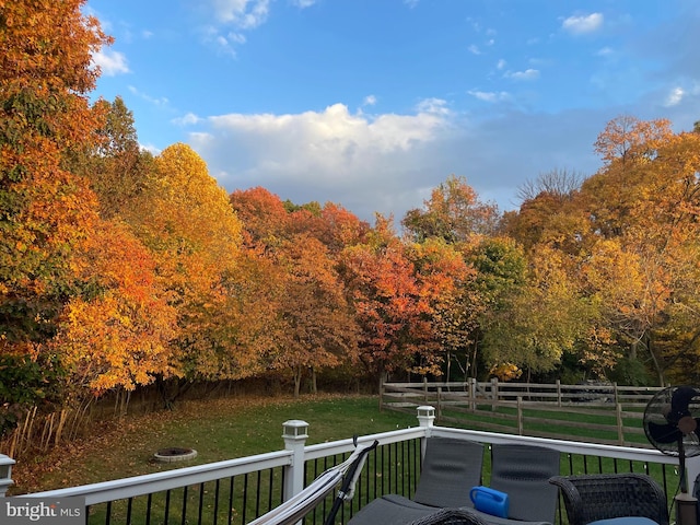 wooden terrace with a lawn