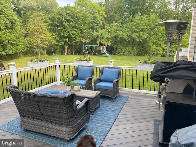 deck with a yard, outdoor lounge area, and a playground