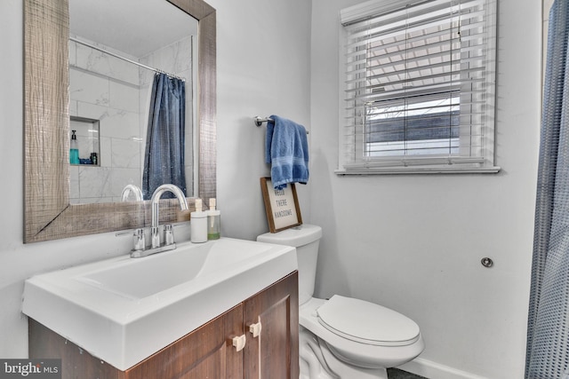 bathroom featuring vanity, toilet, and a shower with shower curtain