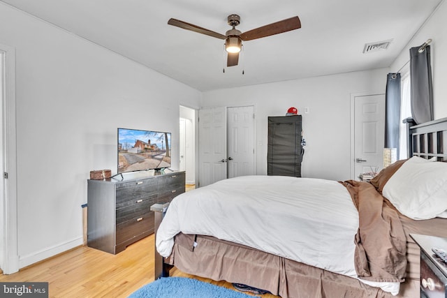 bedroom with ceiling fan and light hardwood / wood-style floors