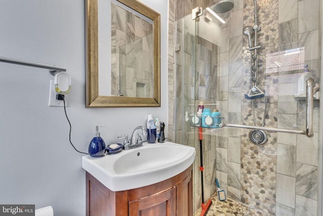 bathroom featuring vanity and a shower with shower door