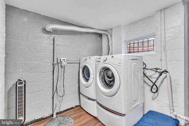 laundry area with hardwood / wood-style flooring and washing machine and clothes dryer