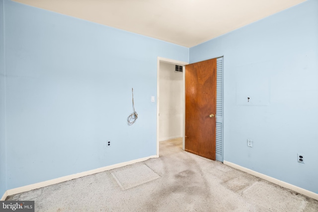 empty room featuring light colored carpet