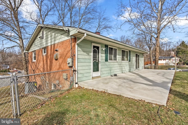 single story home with a front yard and a patio area