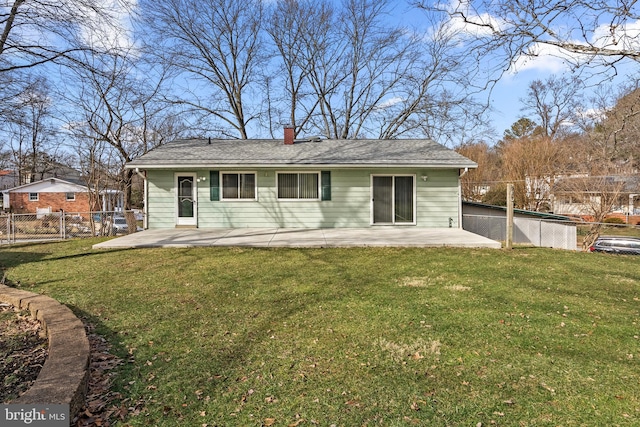 back of house with a patio and a lawn