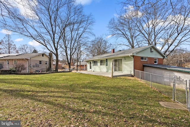 rear view of property featuring a yard and a patio area