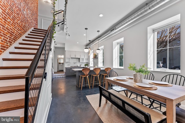 dining room with a towering ceiling