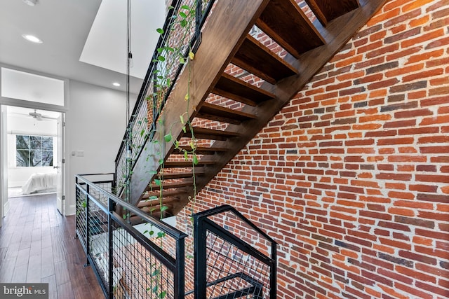 staircase with hardwood / wood-style flooring