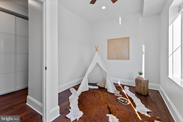 playroom featuring ceiling fan and dark hardwood / wood-style flooring