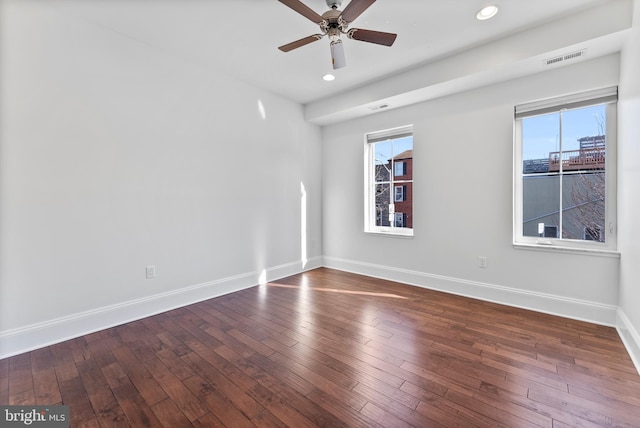 unfurnished room with dark hardwood / wood-style floors and ceiling fan