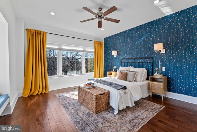 bedroom featuring ceiling fan and dark hardwood / wood-style floors