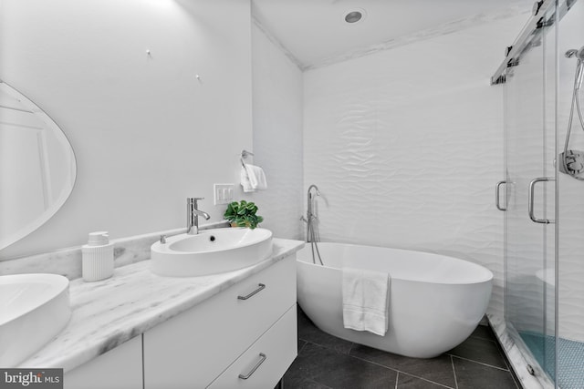 bathroom featuring vanity, tile patterned floors, and separate shower and tub