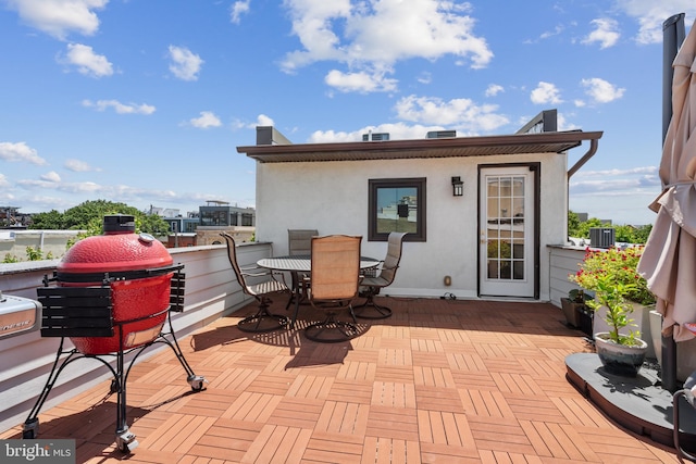 view of patio with central AC and a balcony