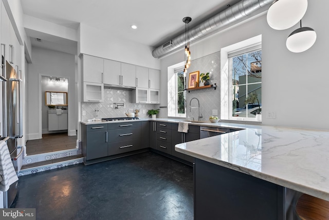 kitchen featuring decorative light fixtures, a kitchen breakfast bar, kitchen peninsula, and white cabinets