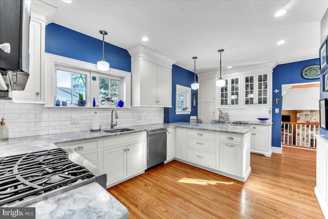 kitchen with hanging light fixtures, sink, and white cabinets