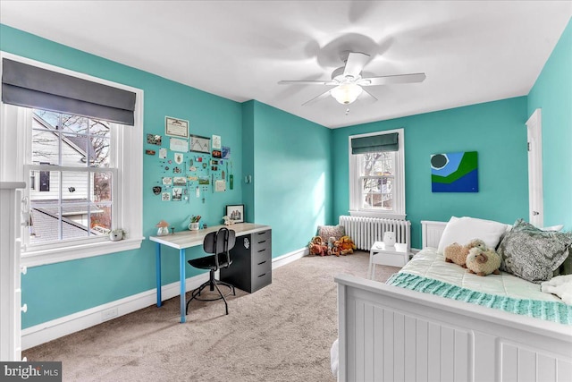 carpeted bedroom featuring ceiling fan and radiator