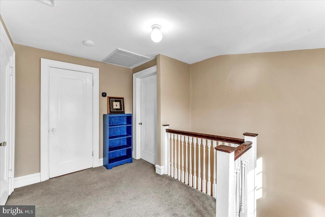 hallway featuring light carpet