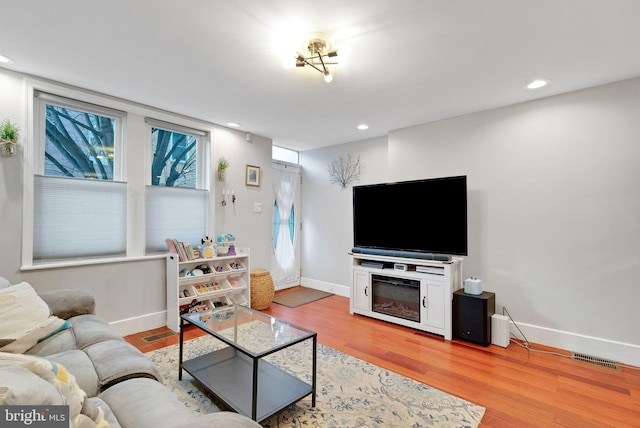 living room featuring a wealth of natural light and light wood-type flooring