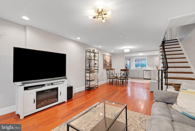 living room with sink and light hardwood / wood-style floors