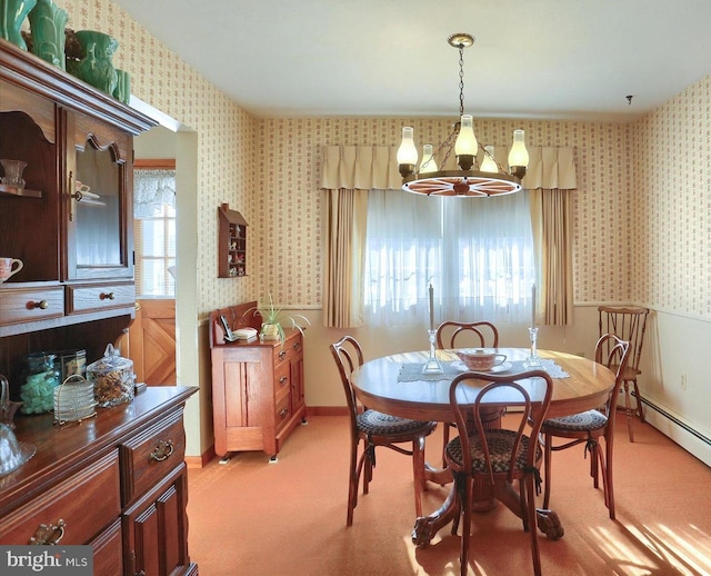 carpeted dining space with an inviting chandelier and a baseboard heating unit