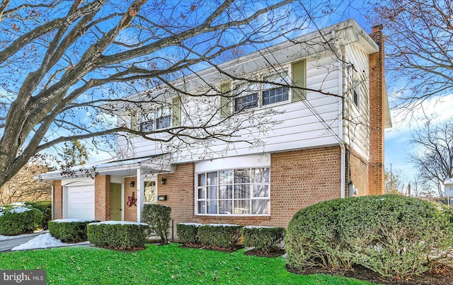 view of front of property with a garage and a front lawn