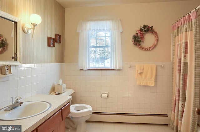 bathroom with tile walls, a baseboard heating unit, vanity, toilet, and walk in shower