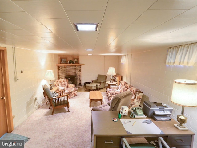 living room with a brick fireplace and carpet floors