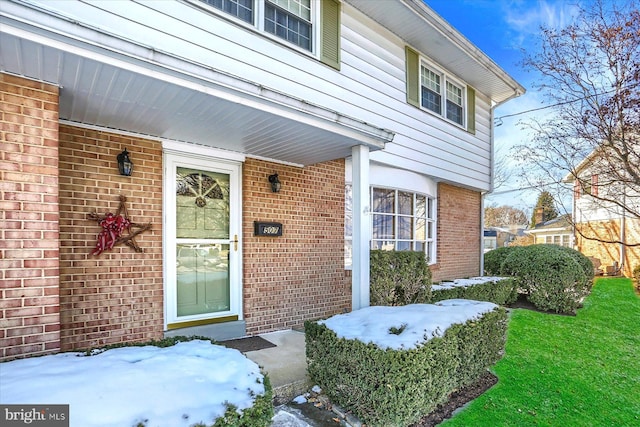 view of snow covered property entrance