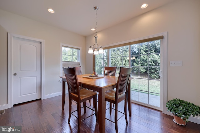 dining room featuring dark hardwood / wood-style flooring and an inviting chandelier